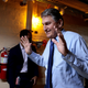 Sen. Joe Manchin walking with his hands up and flashing a smile in the basement of the Capitol.